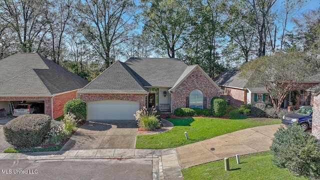 view of front of property featuring a front lawn and a garage