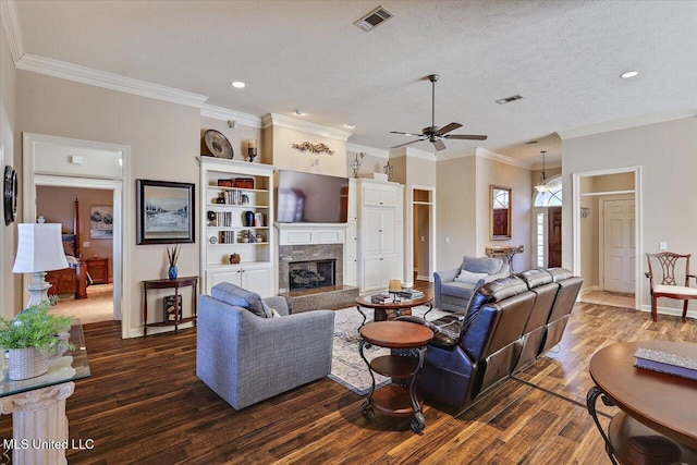 living room featuring dark hardwood / wood-style floors, ceiling fan, crown molding, and a textured ceiling