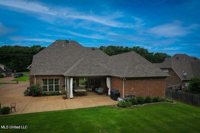 back of house with a yard and a patio area