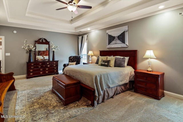 carpeted bedroom featuring ceiling fan, a raised ceiling, and crown molding