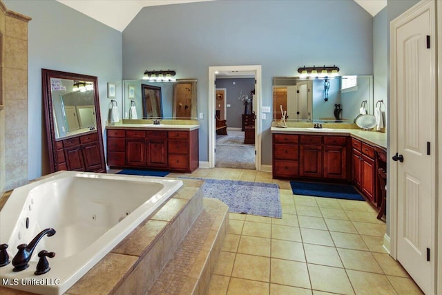 bathroom featuring vanity, tiled tub, and tile patterned floors