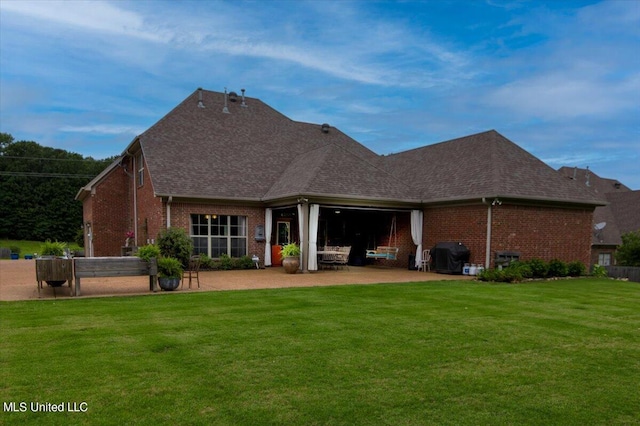 back of house with a patio and a yard