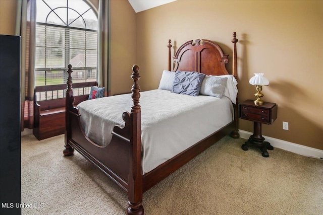 bedroom with vaulted ceiling and carpet flooring