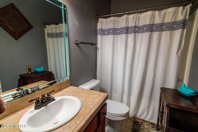 bathroom featuring toilet, curtained shower, vanity, and tile patterned flooring