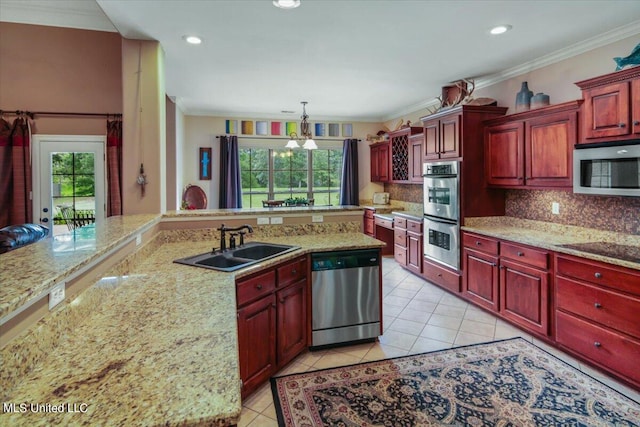 kitchen with a healthy amount of sunlight, stainless steel appliances, tasteful backsplash, and decorative light fixtures