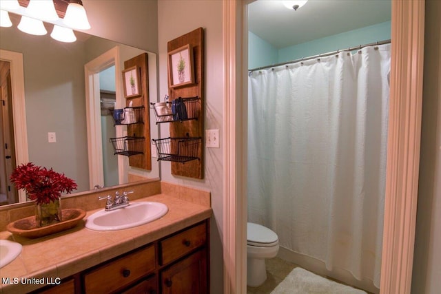 bathroom featuring vanity, curtained shower, and toilet