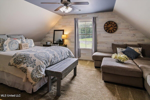 carpeted bedroom with wooden walls, vaulted ceiling, and ceiling fan