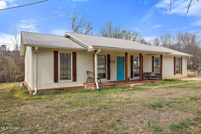 single story home with metal roof, a porch, crawl space, and a front yard