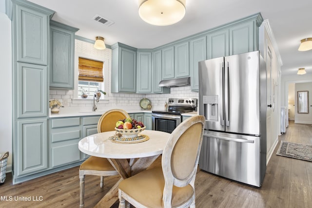 kitchen with tasteful backsplash, sink, dark hardwood / wood-style floors, and appliances with stainless steel finishes