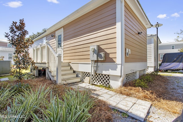 view of side of home featuring central AC