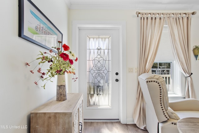 doorway featuring light wood-type flooring and ornamental molding