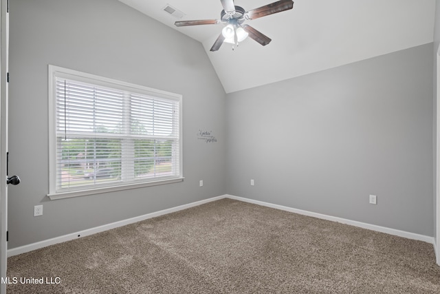 spare room with a ceiling fan, carpet flooring, vaulted ceiling, and baseboards