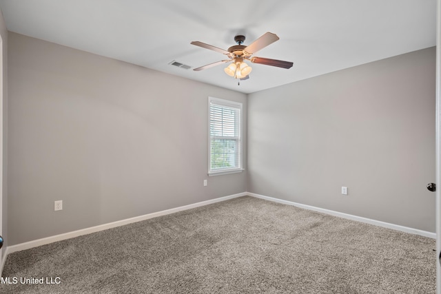 empty room featuring carpet floors, visible vents, baseboards, and a ceiling fan