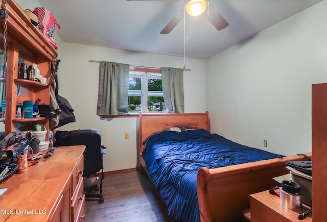 bedroom featuring wood finished floors, ceiling fan, and baseboards