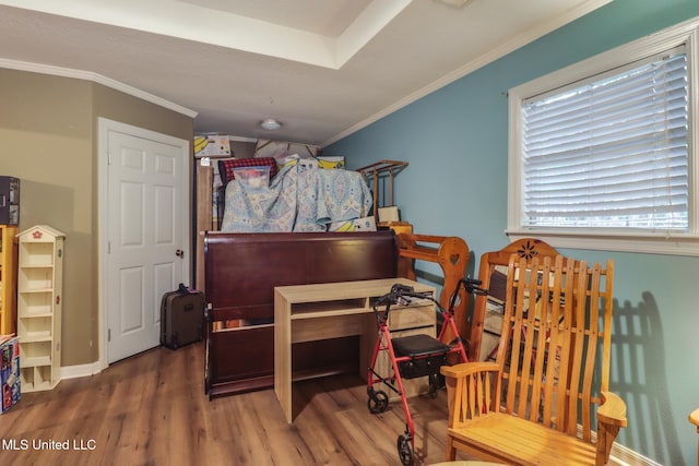 bedroom featuring baseboards, crown molding, and wood finished floors