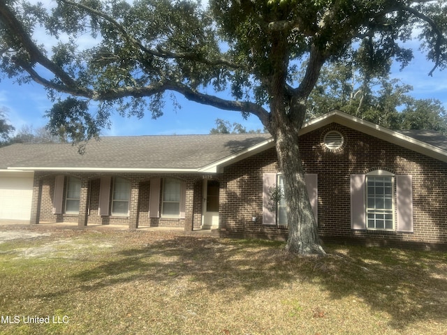 ranch-style home with a garage and a front yard