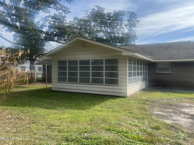 back of property featuring a yard