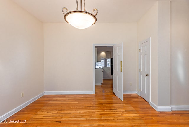 unfurnished room with light wood-type flooring