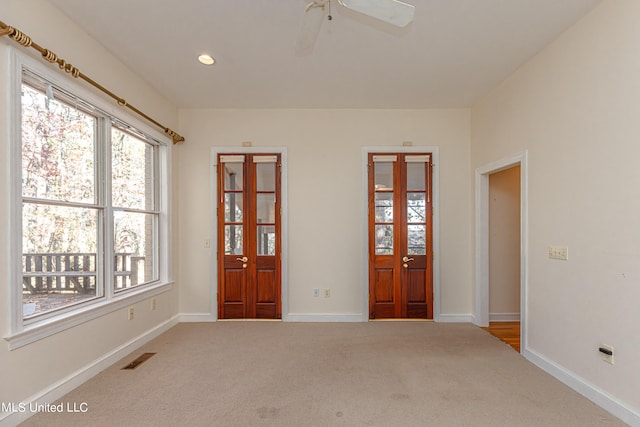 carpeted spare room with ceiling fan
