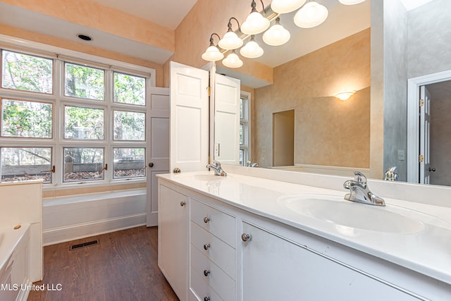 bathroom featuring vanity, hardwood / wood-style floors, and a bathing tub