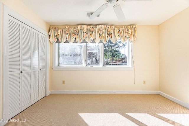 unfurnished bedroom featuring a closet, carpet floors, and ceiling fan