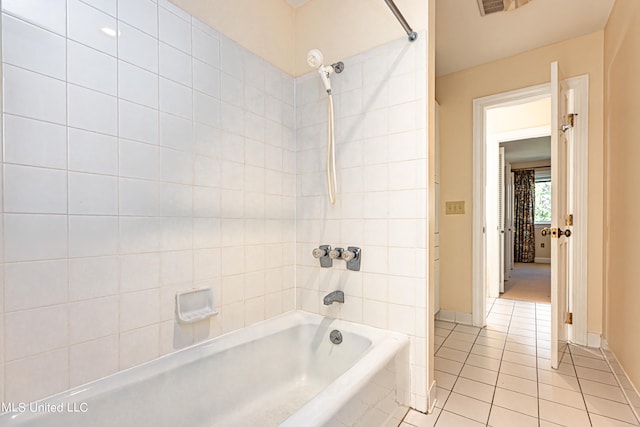 bathroom with tiled shower / bath combo and tile patterned floors