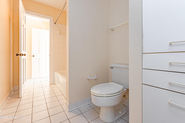 bathroom with toilet, tile patterned floors, and washtub / shower combination