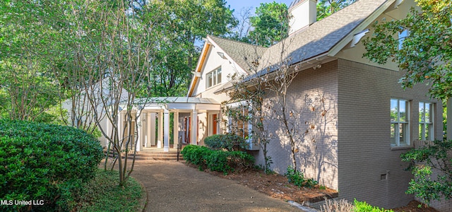 view of property exterior with a pergola