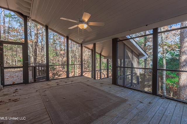 unfurnished sunroom with wood ceiling and ceiling fan