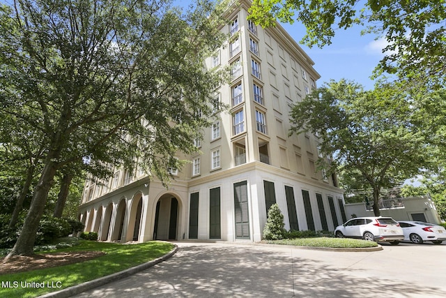 view of property featuring concrete driveway