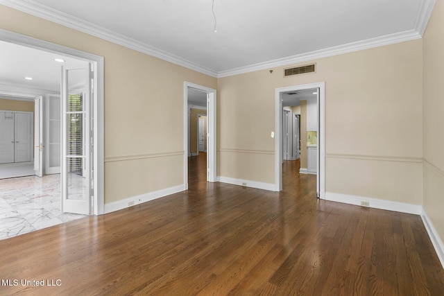 spare room with wood-type flooring and ornamental molding