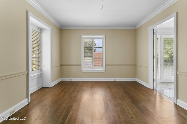 unfurnished room with ornamental molding, baseboards, and wood finished floors