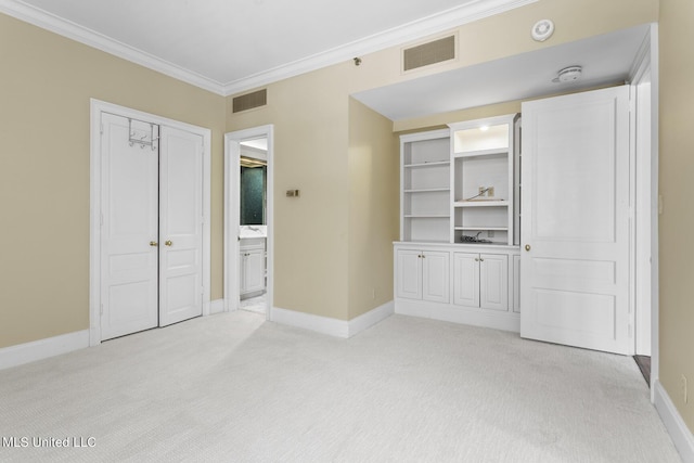 unfurnished bedroom featuring light colored carpet, crown molding, visible vents, and baseboards