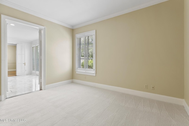 unfurnished bedroom featuring light colored carpet, ornamental molding, and baseboards