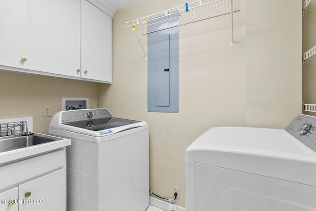 laundry area with washer and dryer, cabinet space, and electric panel