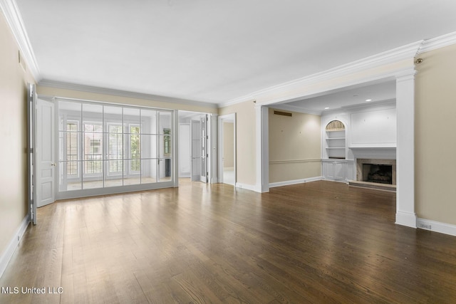 unfurnished living room with wood finished floors, built in shelves, baseboards, and ornamental molding