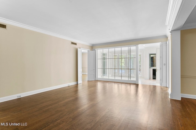 unfurnished room featuring ornamental molding and wood-type flooring