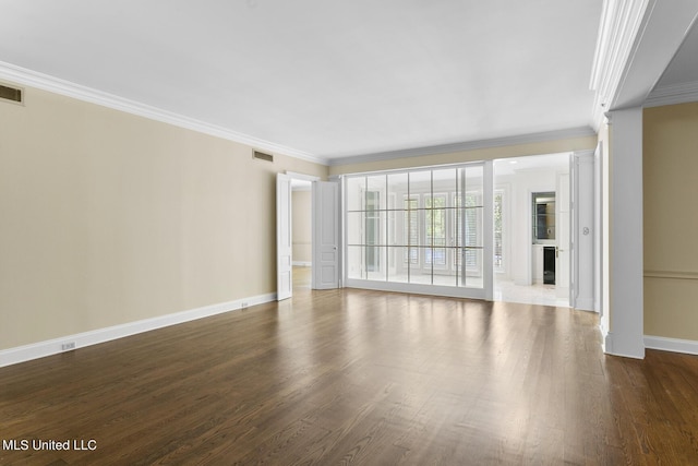 unfurnished living room featuring crown molding, baseboards, dark wood-style floors, and visible vents