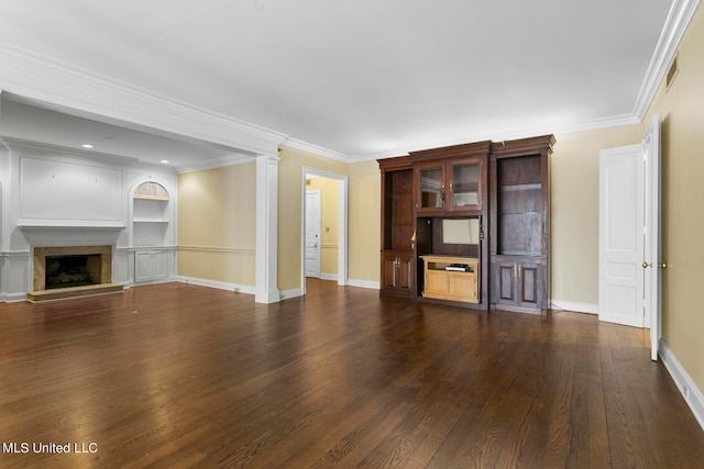 unfurnished living room with crown molding, ornate columns, and dark hardwood / wood-style floors