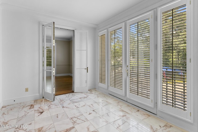 interior space with baseboards, marble finish floor, and crown molding