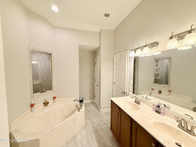 3020 Makenlee St, Southaven, MS 38672 - full bathroom with a bath, double vanity, and baseboards