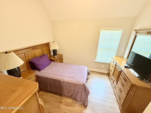 3020 Makenlee St, Southaven, MS 38672 - bedroom with light wood-type flooring, lofted ceiling, multiple windows, and baseboards
