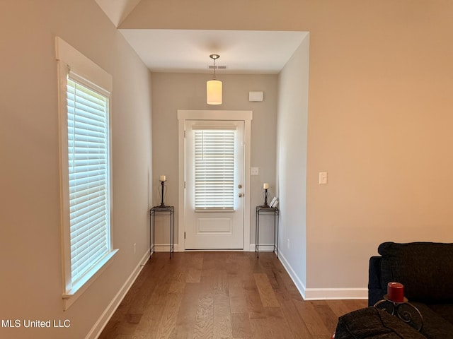 3020 Makenlee St, Southaven, MS 38672 - doorway to outside featuring dark wood finished floors, healthy amount of natural light, and baseboards