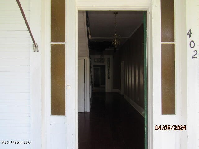 corridor with an inviting chandelier