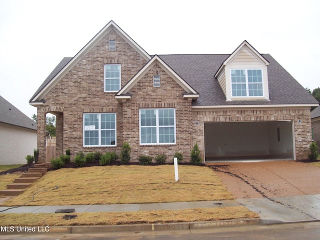 view of front of property featuring a front yard and a garage