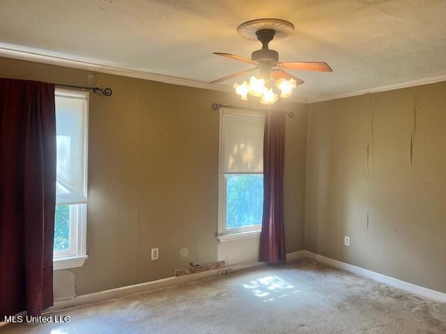 spare room featuring crown molding, light carpet, and ceiling fan