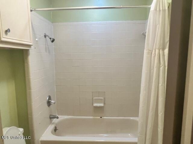 bathroom with toilet and shower / bathtub combination with curtain