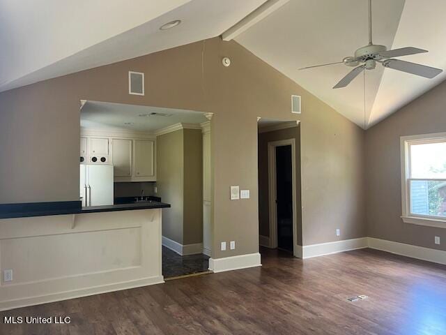 interior space featuring dark hardwood / wood-style flooring, ceiling fan, vaulted ceiling with beams, and white refrigerator