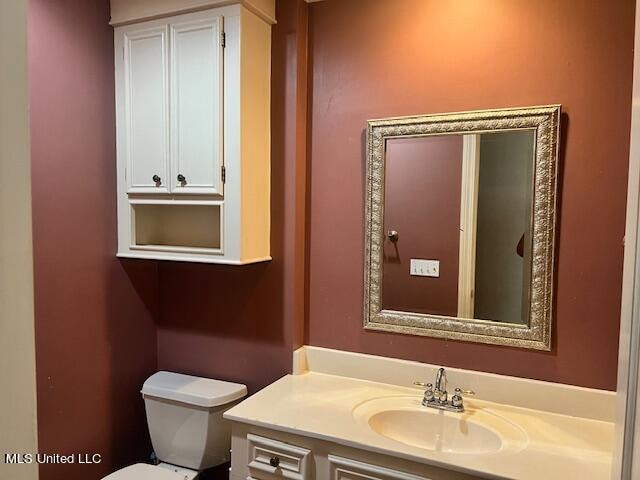 bathroom with toilet and vanity