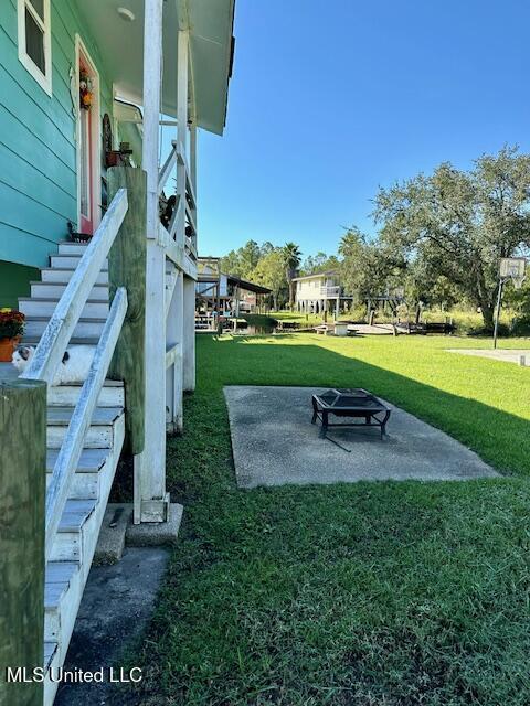 view of yard with a fire pit